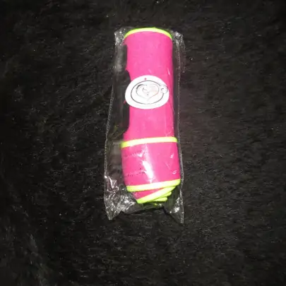 Black mini horse wearing pink and lime boots 2